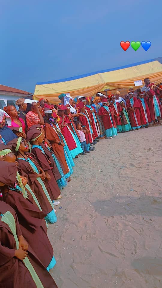 School community celebrating in colourful graduation gowns